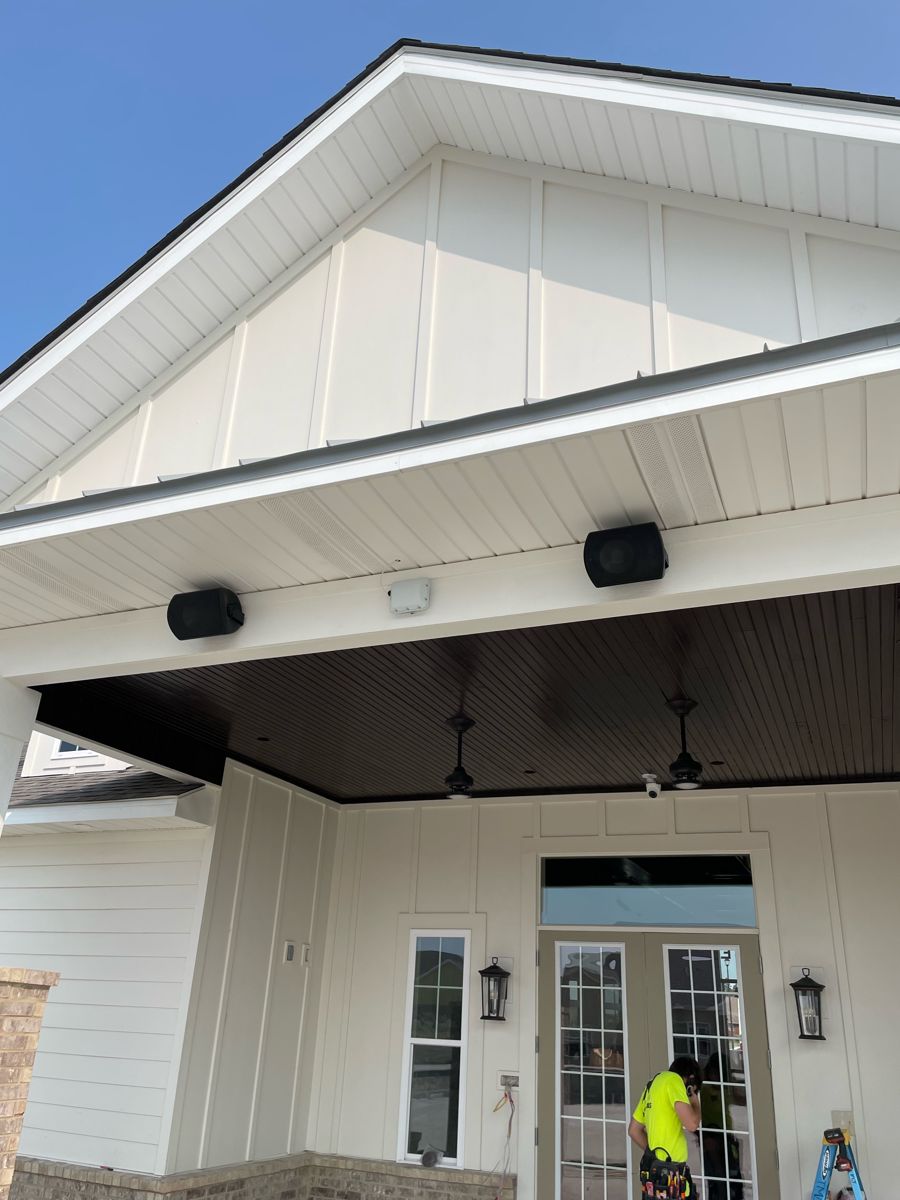 Outdoor security camera and speakers installed by NeuraTech Security